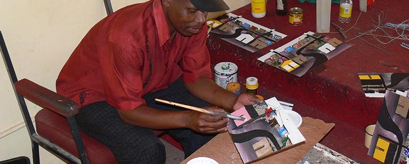 Artist Mgadi making 3d painting out of recycled trash